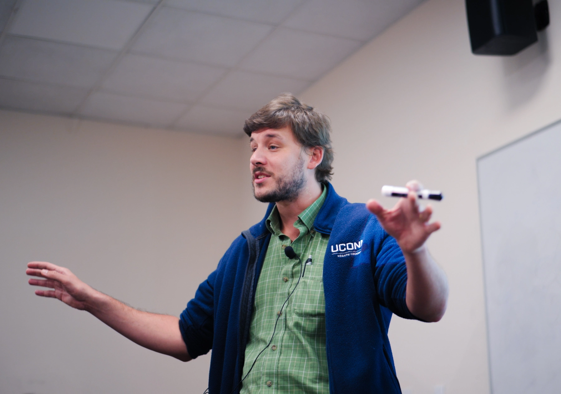 UConn's Business Analytics and Project Managment faculty member giving lecture in a classroom