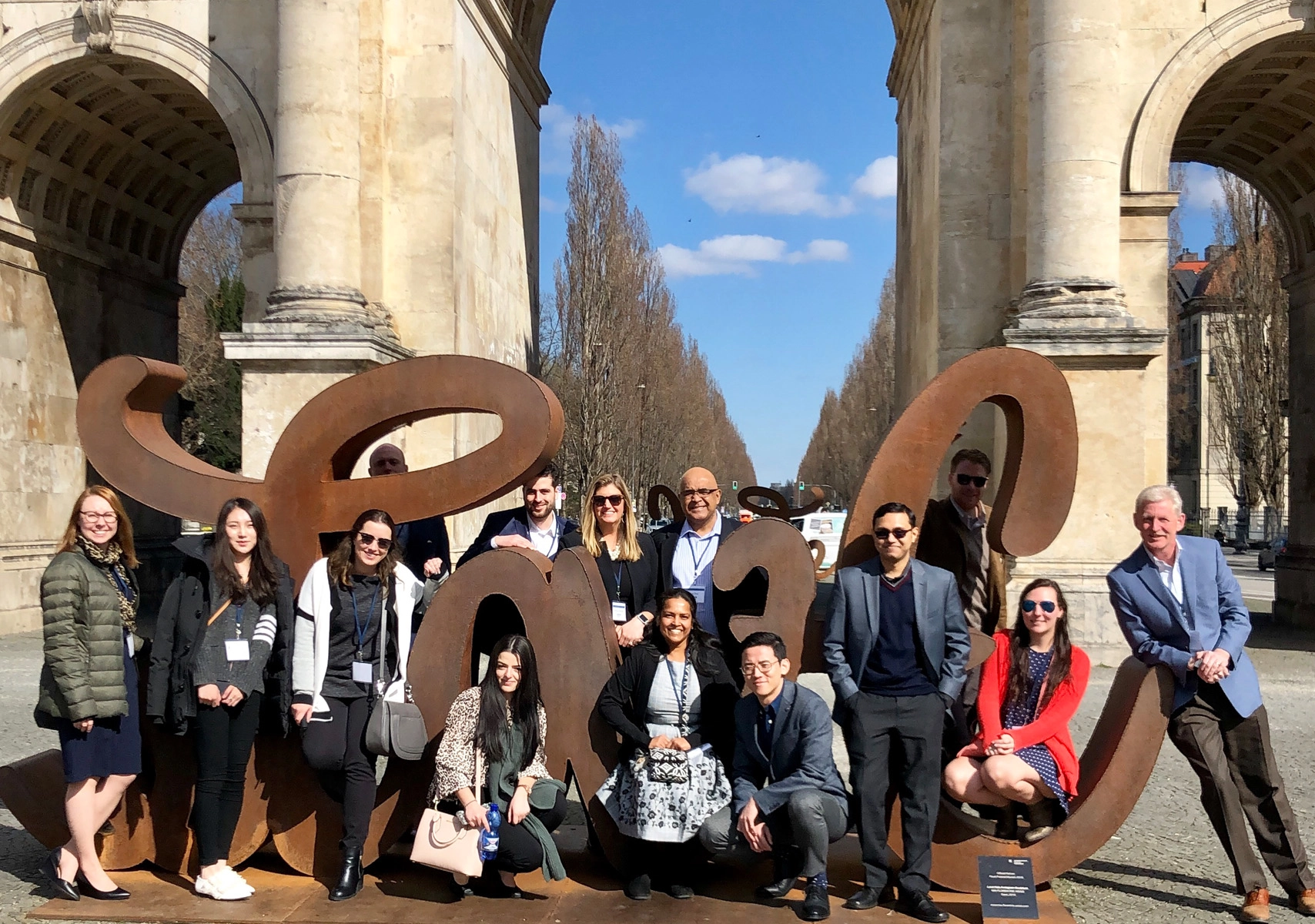 UConn's Business Analytics and Project Managment students posing for photo in front of sculpture.